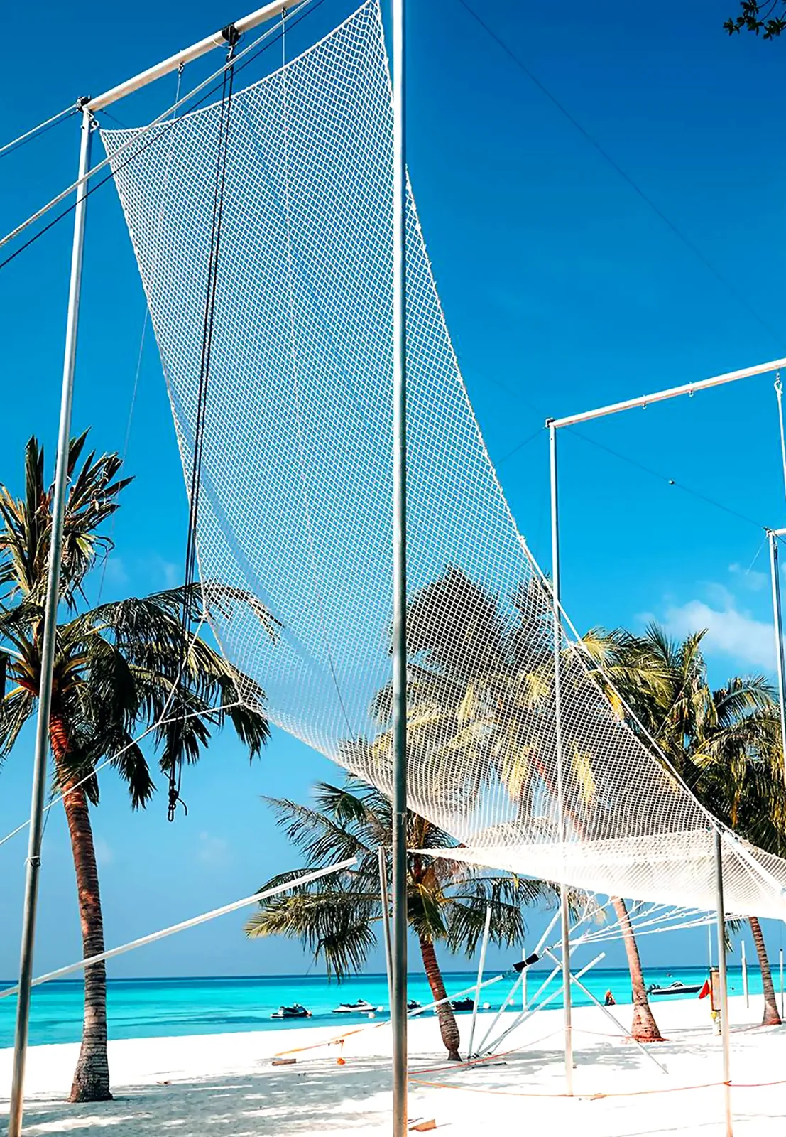 Full-size flying trapeze rig installed on a beachfront — Maldives resort — MACA flying trapeze rig