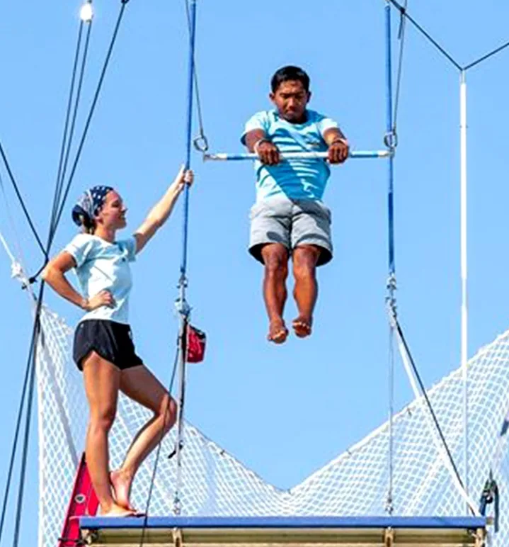 Operator training on the pedestal board of a flying trapeze rig — MACA flying trapeze rig